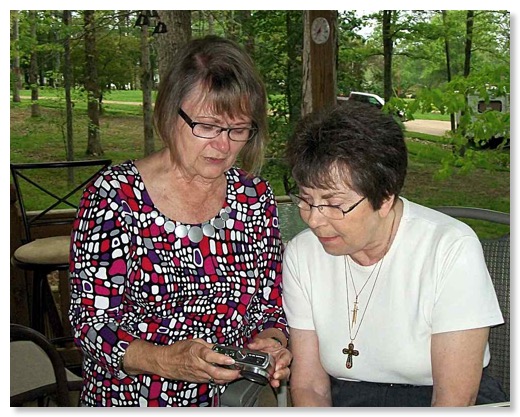 Lorraine shows Barbara some pictures.